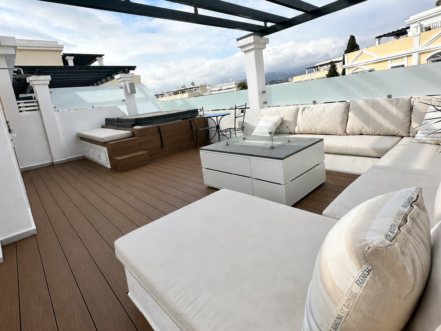 Furnished rooftop terrace beneath a pergola in Aloha Gardens