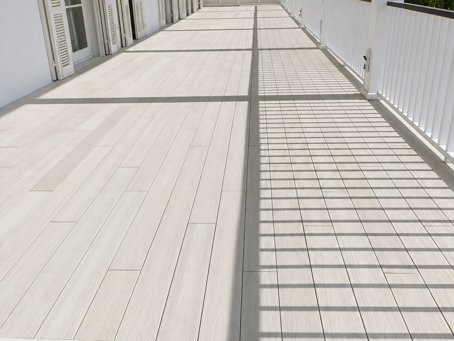 Long balcony deck with clean door transitions in Finca Cortesin