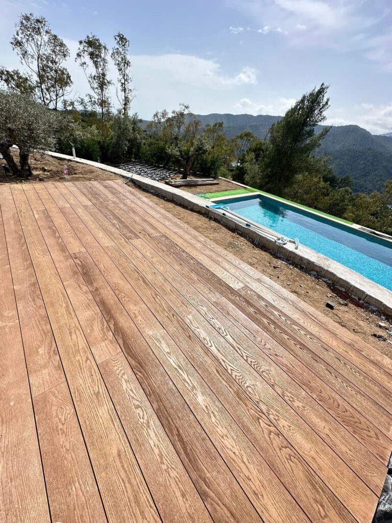 Millboard Coppered Oak terrace beside a pool with mountain views in Istán